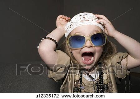 Stock Image - Girl (2-4) dressed for partying, having fun.. Fotosearch