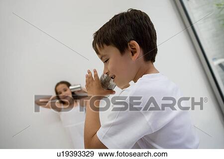 Girl and Boy using a tin can as a phone. View Large Photo Image Stock Photo - Girl and Boy using a tin can as a phone.. Fotosearch