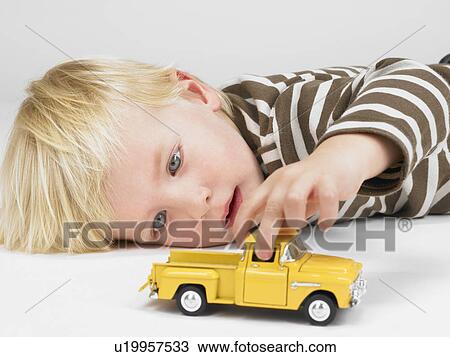 Little boy playing with yellow truck. View Large Photo Image Stock Image - Little boy playing with yellow truck. . Fotosearch