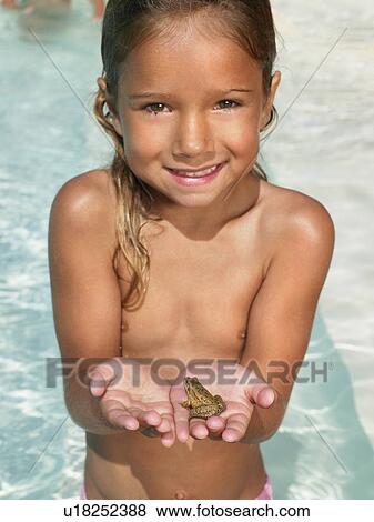 Stock Photo - Little girl holding a frog.. Fotosearch