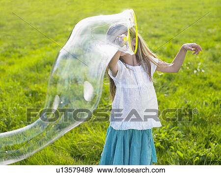 Little girl making soap bubbles. View Large Photo Image Stock Photo - Little girl making soap bubbles.. Fotosearch