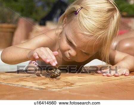 Little girl playing with a snail. View Large Photo Image Stock Image - Little girl playing with a snail.. Fotosearch