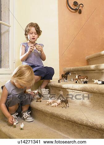 Little girls with plastic animals. View Large Photo Image Stock Image - Little girls with plastic animals.. Fotosearch