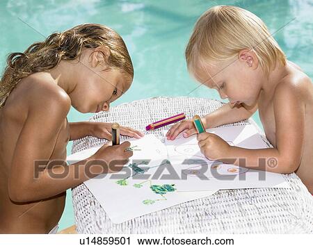 Stock Image - Two young children coloring by a pool.. Fotosearch