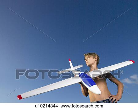 Young boy ready to send off an airplane. View Large Photo Image Picture - Young boy ready to send off an airplane.. Fotosearch