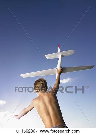 Young boy ready to send off an airplane. View Large Photo Image Stock Photo - Young boy ready to send off an airplane.. Fotosearch