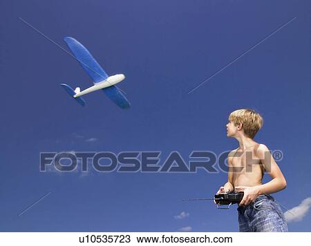 Stock Image - Young boy with remote-control.. Fotosearch