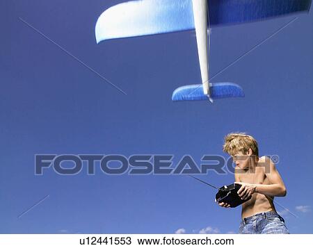 Stock Image - Young boy with remote-control. . Fotosearch