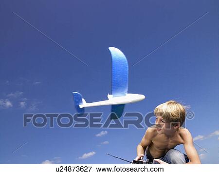 Stock Photo - Young boy with remote-control.. Fotosearch