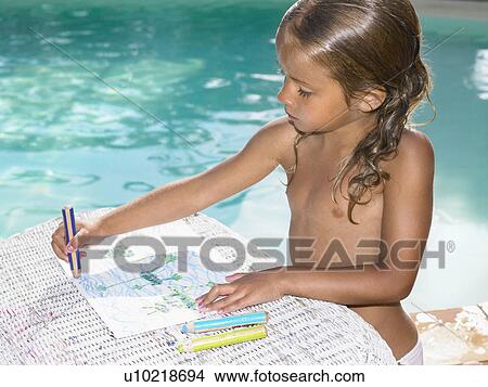 Young girl coloring by a pool. View Large Photo Image Picture - Young girl coloring by a pool.. Fotosearch