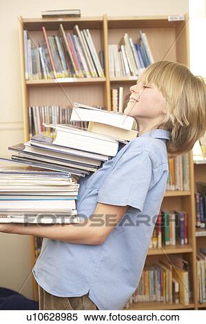Boy carrying books, smiling View Large Photo Image Stock Photography - Boy carrying books, smiling. Fotosearch