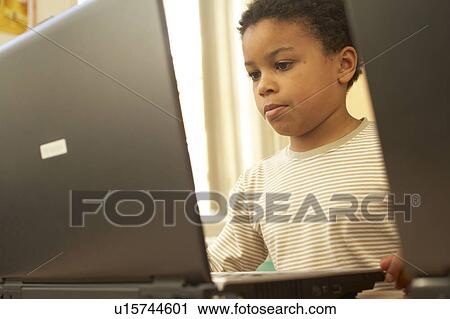 Stock Image - Boy on computer. Fotosearch