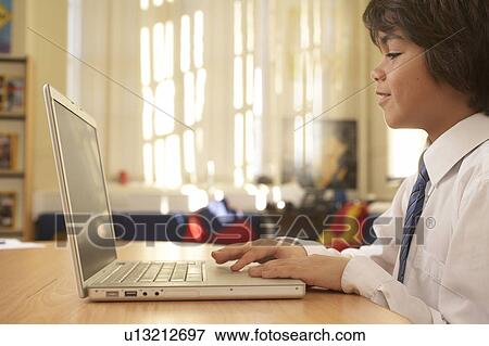 Stock Photo - Boy on computer. Fotosearch