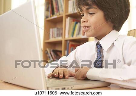 Stock Photography - Boy on computer. Fotosearch