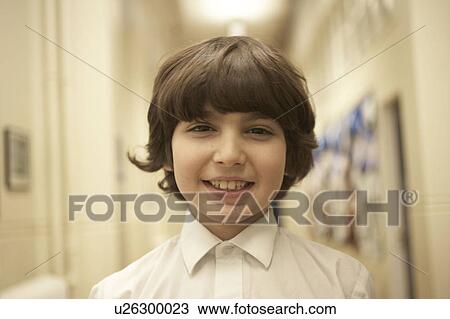 Boy standing in school's corridor View Large Photo Image Stock Image - Boy standing in school's corridor. Fotosearch