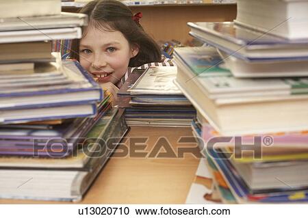 Girl behind lots of books View Large Photo Image Stock Image - Girl behind lots of books. Fotosearch