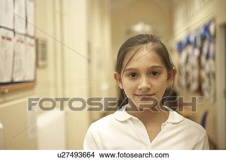 Girl standing in school's corridor View Large Photo Image Picture - Girl standing in school's corridor. Fotosearch