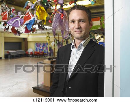 Male teacher in school hall View Large Photo Image Stock Image - Male teacher in school hall. Fotosearch