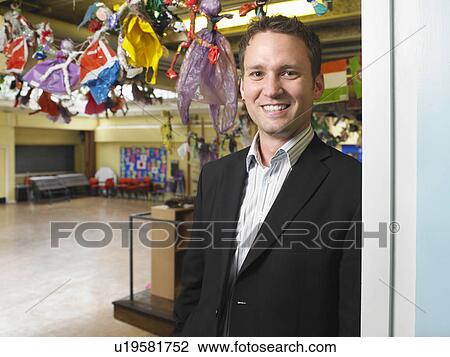Male teacher in school hall View Large Photo Image Stock Image - Male teacher in school hall. Fotosearch