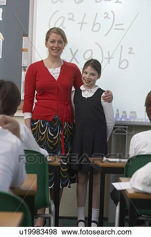 Stock Photo - Teacher and girl in front of whiteboard. Fotosearch