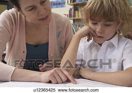Teacher giving explanation to student View Large Photo Image Stock Photography - Teacher giving explanation to student. Fotosearch