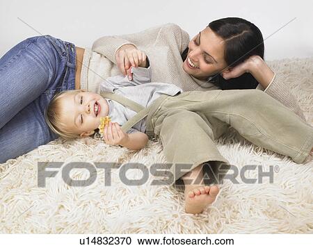 Stock Image - Daughter and mother playing.. Fotosearch