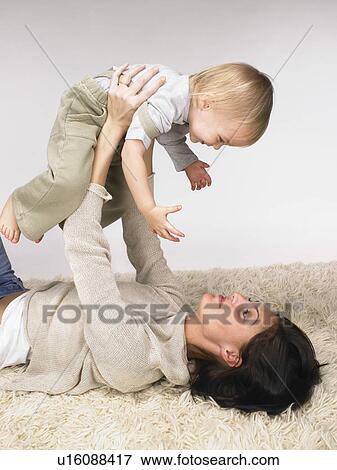 Stock Photo - Daughter and mother playing.. Fotosearch