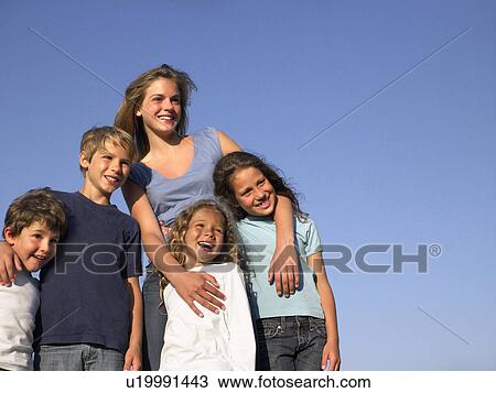 Stock Image - Group of kids looking at the horizon.. Fotosearch