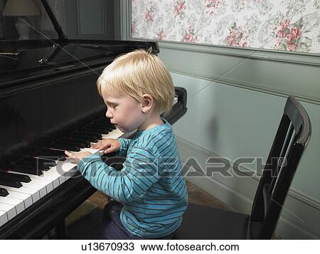 Little boy playing piano. View Large Photo Image Stock Image - Little boy playing piano.. Fotosearch