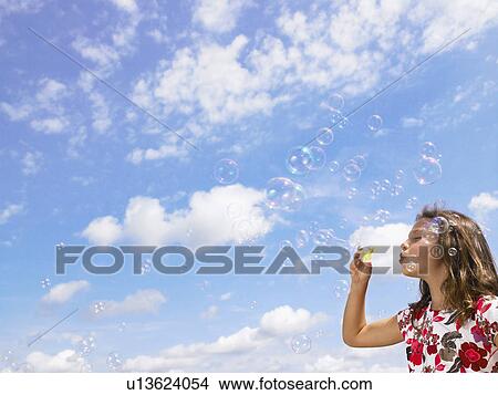 Little girl blowing bubbles. View Large Photo Image Picture - Little girl blowing bubbles.. Fotosearch