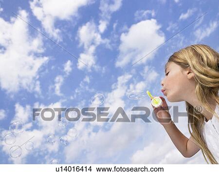 Picture - Little girl blowing bubbles.. Fotosearch