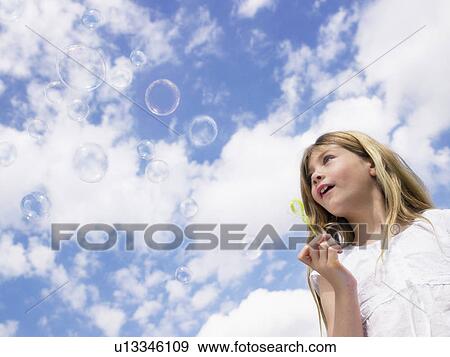 Little girl blowing bubbles. View Large Photo Image Stock Photo - Little girl blowing bubbles.. Fotosearch