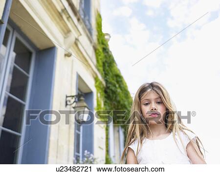 Stock Image - Little girl looking at camera.. Fotosearch