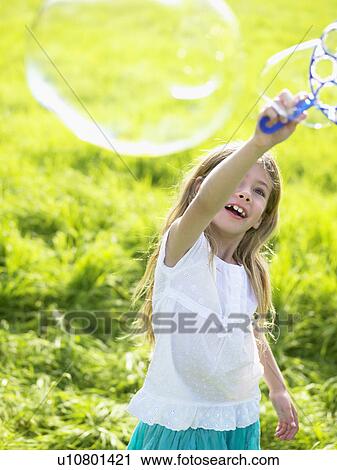 Little girl making soap bubbles. View Large Photo Image Stock Image - Little girl making soap bubbles.. Fotosearch