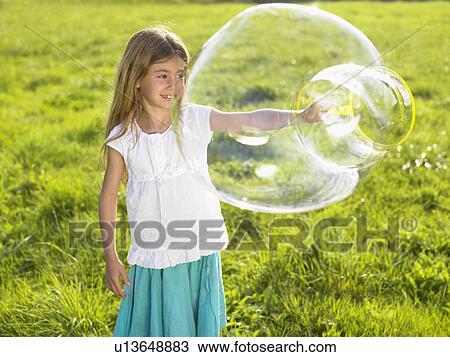 Little girl making soap bubbles. View Large Photo Image Stock Image - Little girl making soap bubbles.. Fotosearch