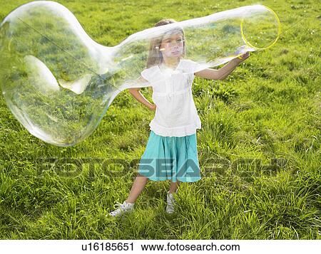 Little girl making soap bubbles. View Large Photo Image Stock Image - Little girl making soap bubbles.. Fotosearch