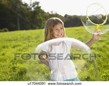 Little girl making soap bubbles. View Large Photo Image Stock Image - Little girl making soap bubbles.. Fotosearch