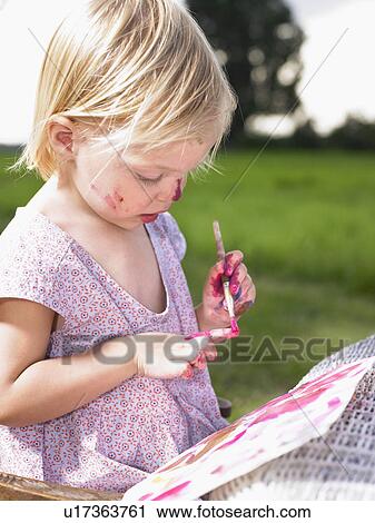 Little girl painting in a green field. View Large Photo Image Stock Image - Little girl painting in a green field.. Fotosearch