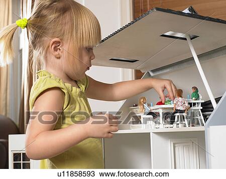 Little girl playing with a doll house View Large Photo Image Stock Image - Little girl playing with a doll house. Fotosearch