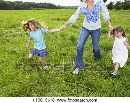 Mother and daughters in a field. View Large Photo Image Stock Photo - Mother and daughters in a field.. Fotosearch