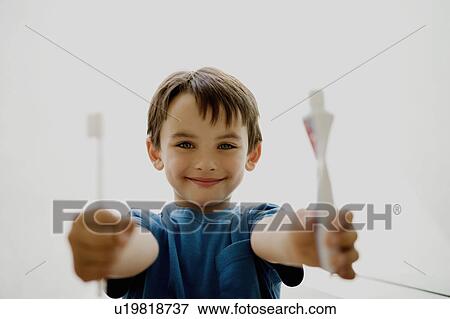 Stock Photo - Portrait of a boy holding toothbrush.. Fotosearch