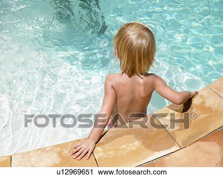 Young boy at ledge of pool. View Large Photo Image Stock Image - Young boy at ledge of pool.. Fotosearch