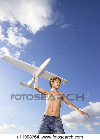 Young boy ready to send off an airplane. View Large Photo Image Picture - Young boy ready to send off an airplane.. Fotosearch