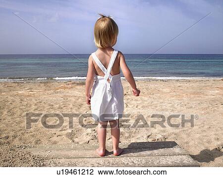 Young boy standing on a wooden path at the beach. View Large Photo Image Stock Image - Young boy standing on a wooden path at the beach.. Fotosearch