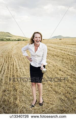 Businesswoman fencing in a wheat field. View Large Photo Image Stock Photograph - Businesswoman fencing in a wheat field.. Fotosearch