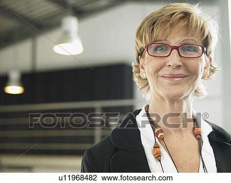 Stock Image - Businesswoman working in an office. Fotosearch