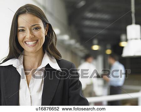 Stock Image - Businesswoman working in an office. Fotosearch