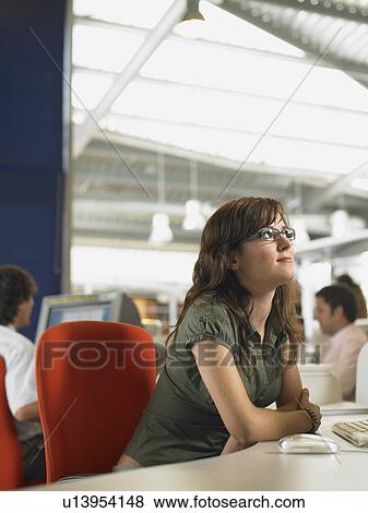Businesswoman working in an office View Large Photo Image Stock Photo - Businesswoman working in an office. Fotosearch