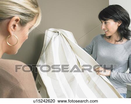 Female interior designer showing samples of striped fabric to client. View Large Photo Image Stock Image - Female interior designer showing samples of striped fabric to client.. Fotosearch