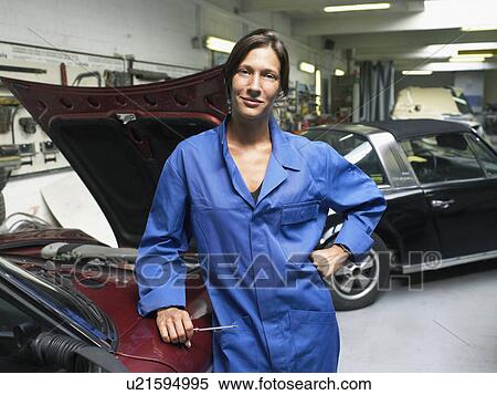 Female worker in front of an open trunk in a garage. View Large Photo Image Stock Photography - Female worker in front of an open trunk in a garage.. Fotosearch